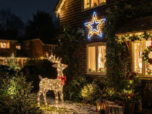 Glowing 3D reindeer and rope light star displays on a house at night