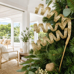 Gold Glitter Swirl Stem (80cm) tucked into a decorated Christmas tree