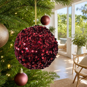 Red Sequins Bauble on a decorated Christmas tree