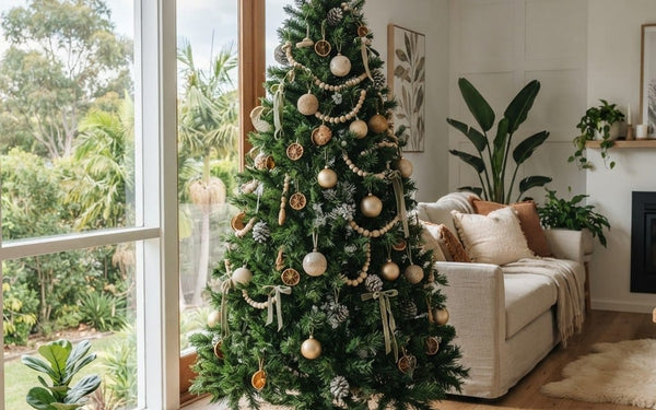 Half-fluffed artificial Christmas tree showing fanned branch tips in an Australian living room