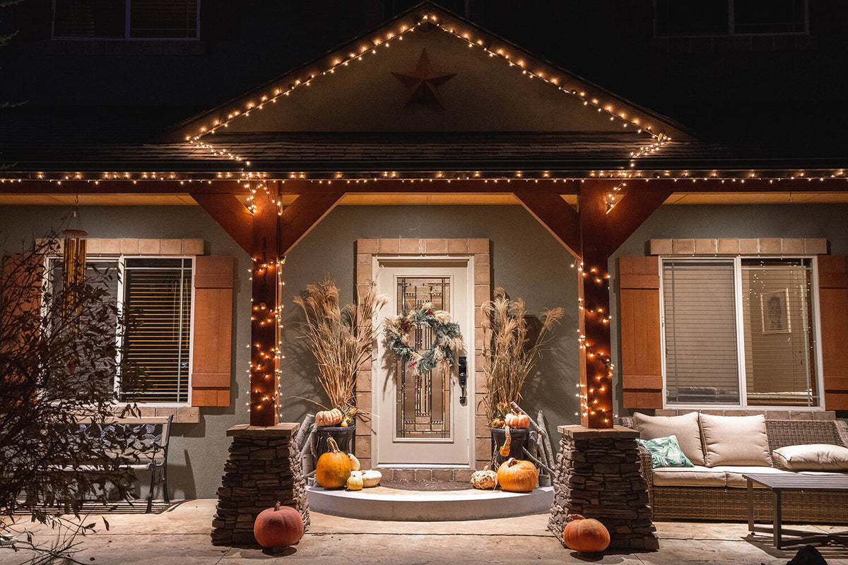 Front verandah Christmas decor with wreath and warm lights