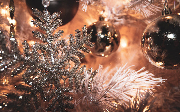 A tall, full Christmas tree in a family living room, measured against the ceiling height