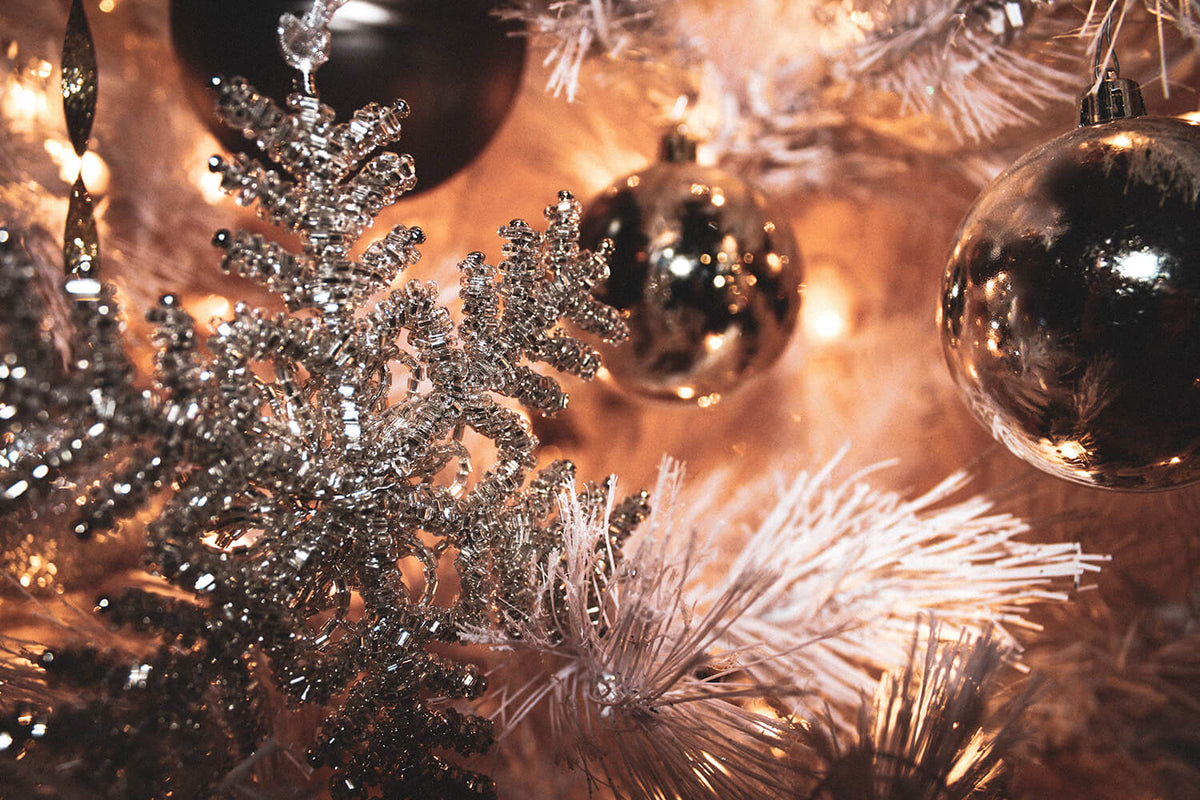 A tall, full Christmas tree in a family living room, measured against the ceiling height