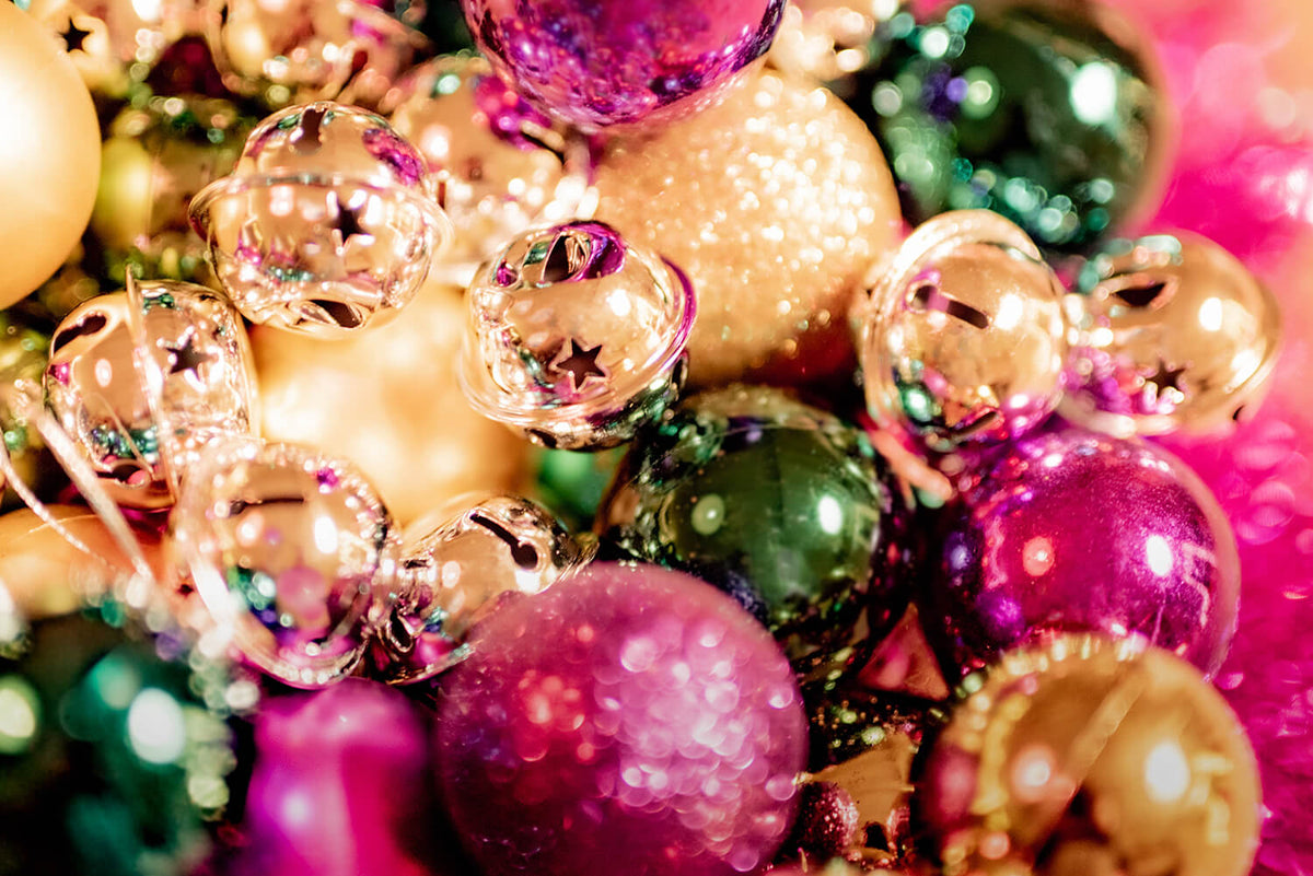 Decorated Christmas tree with baubles, ribbon and warm white lights