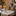 Miniature lit Christmas village houses and figurines on a tabletop