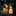 Illuminated solar reindeer and snowman figures in a garden at night