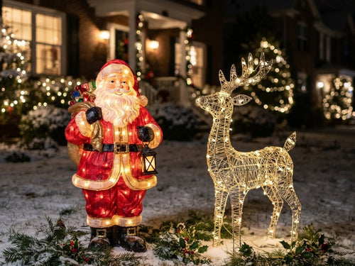 Illuminated outdoor Santa and reindeer figures on a front lawn