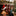 Red and white Christmas stockings, Santa hat and gift sack on a mantel