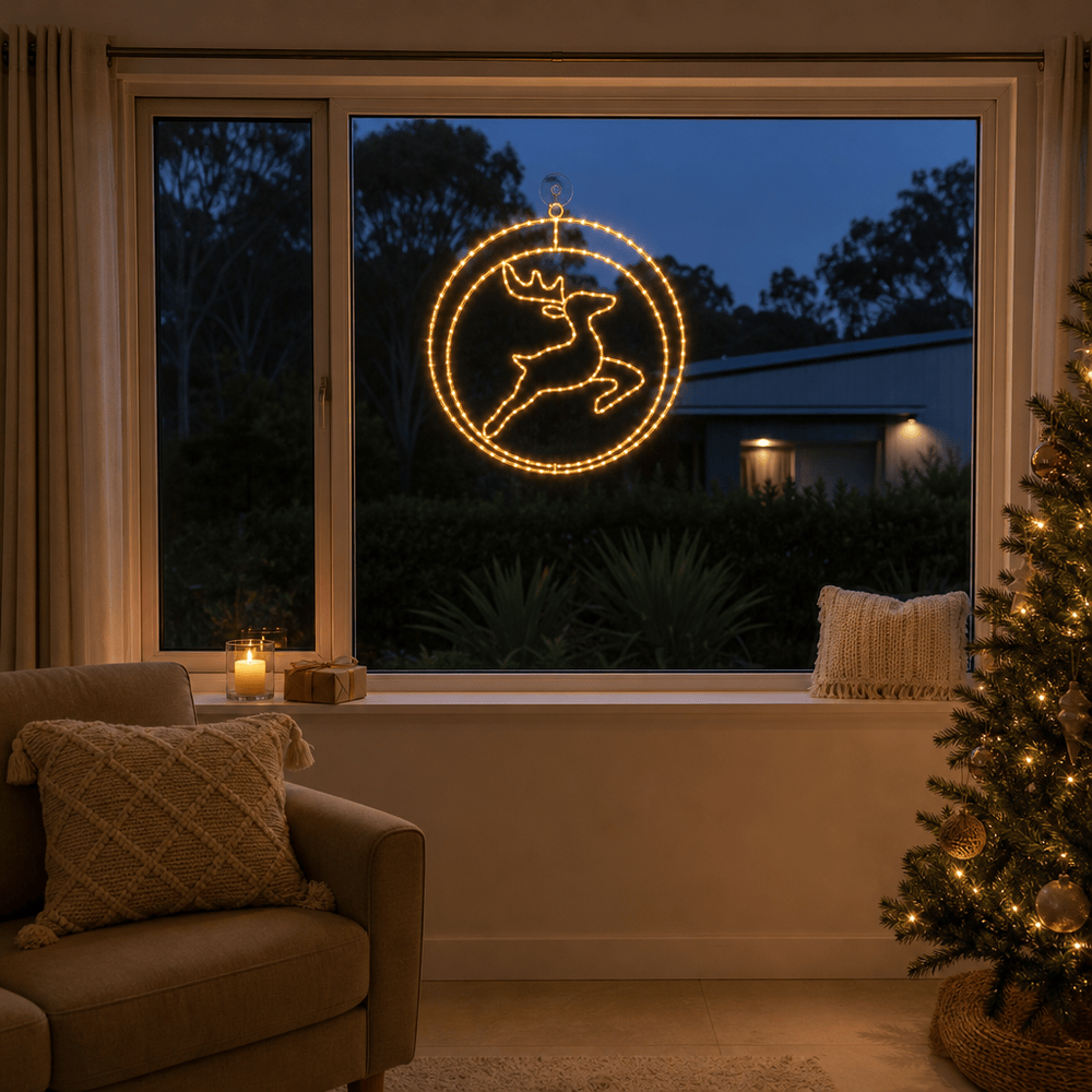 LED Double Rings Reindeer Twinkling Motif (52cm) glowing in a living room window at night