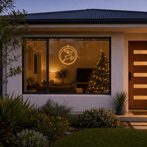 LED Double Rings Reindeer Twinkling Motif (52cm) hanging in a front window at night