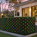 LED Multicoloured Net Light (9.6m) styled in an Australian Christmas setting