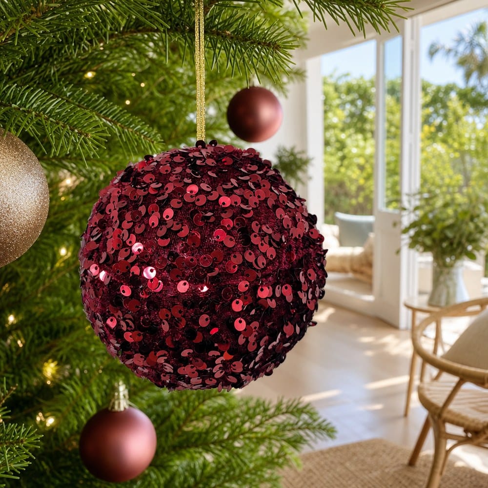 Red Sequins Bauble on a decorated Christmas tree