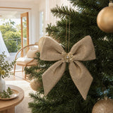 Champagne Bow Ornament on a decorated Christmas tree