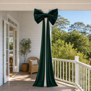 Giant Green Velvet Bow tied to a verandah post, styled in an Australian Christmas setting
