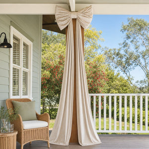 Giant Cream Velvet Bow tied to a verandah post, styled in an Australian Christmas setting