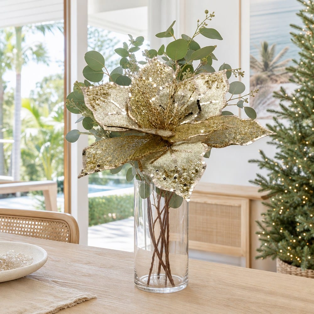 Opulent Gold Poinsettia Stem arranged in a glass vase
