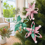 Poinsettia Plush Swirl Clip Asst styled in an Australian Christmas setting