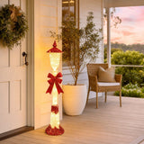 LED Twinkling Glitter Street Lamp Red (1.2m) glowing on a front verandah in an Australian Christmas setting